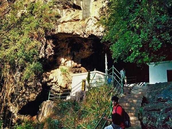 Entrance view of Kavala Caves trekking path and forest steps leading to Kavaleshwara cave temple near Dandeli Karnataka.